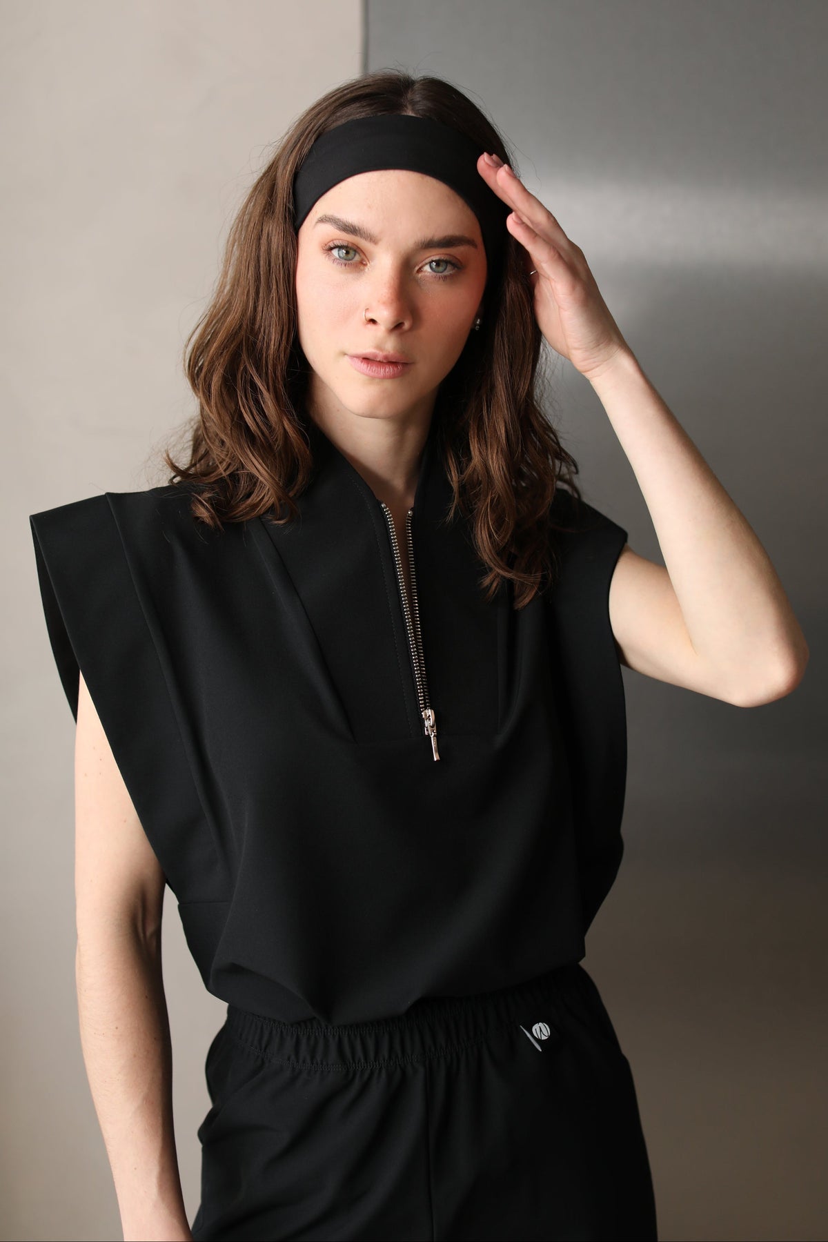 Woman wearing Black Chill Band with black Work & Chill scrubs