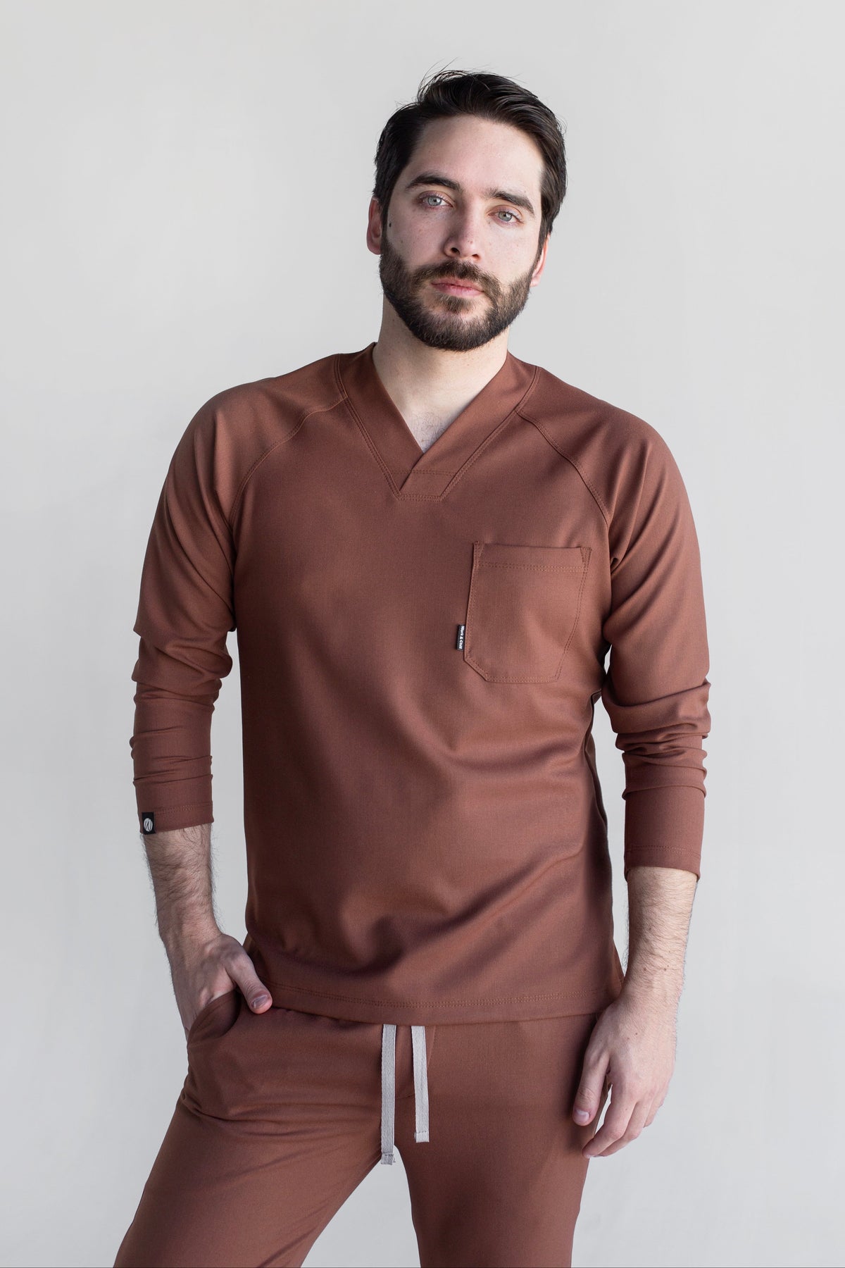 Man wearing Classic Cocoa Scrub Top by Work & Chill