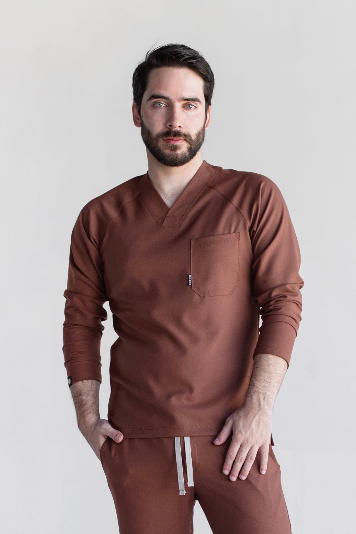 Model wearing Classic Cocoa Scrub Top with matching cocoa scrub pants