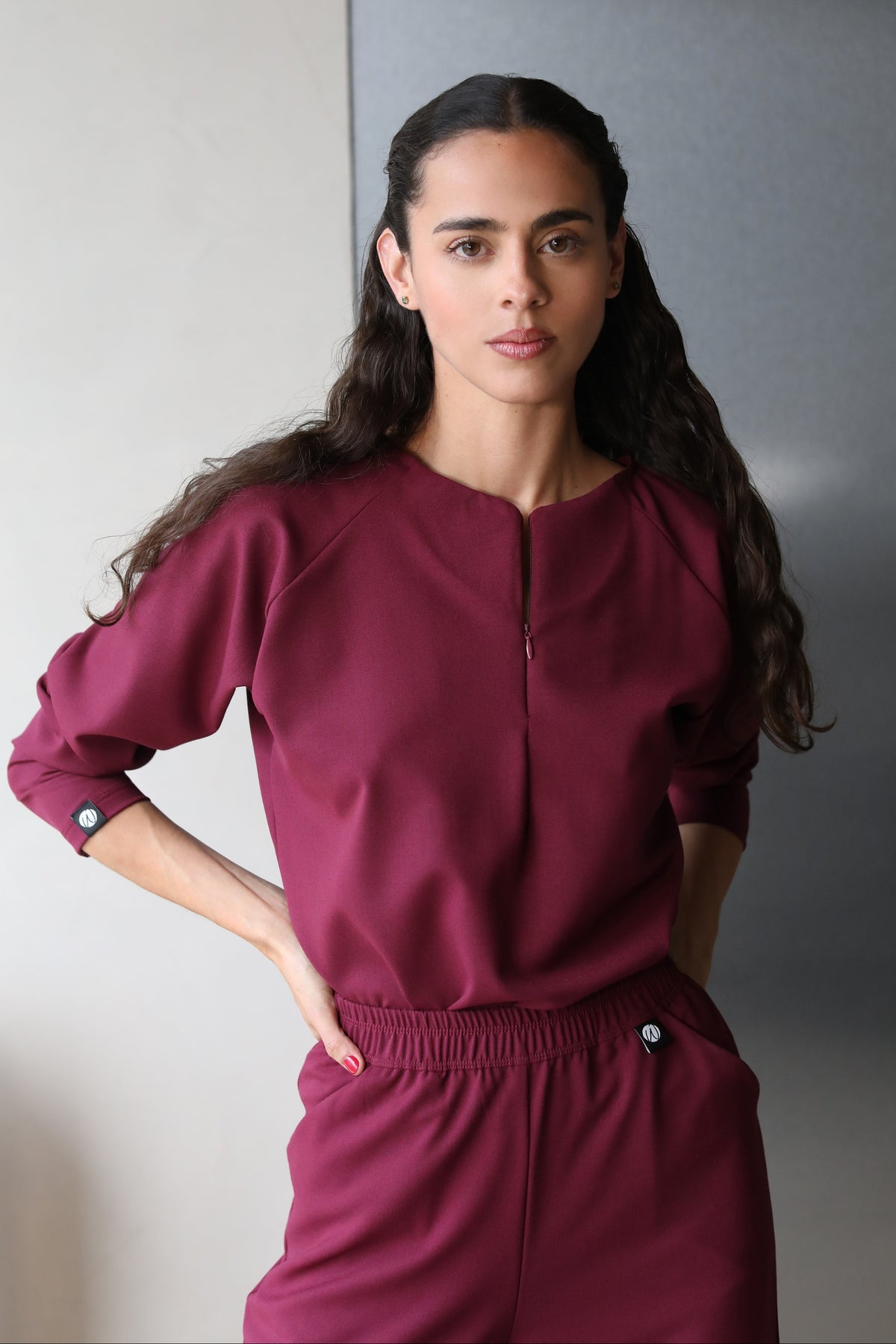 Woman wearing Fall Burgundy Scrub Top by Work & Chill