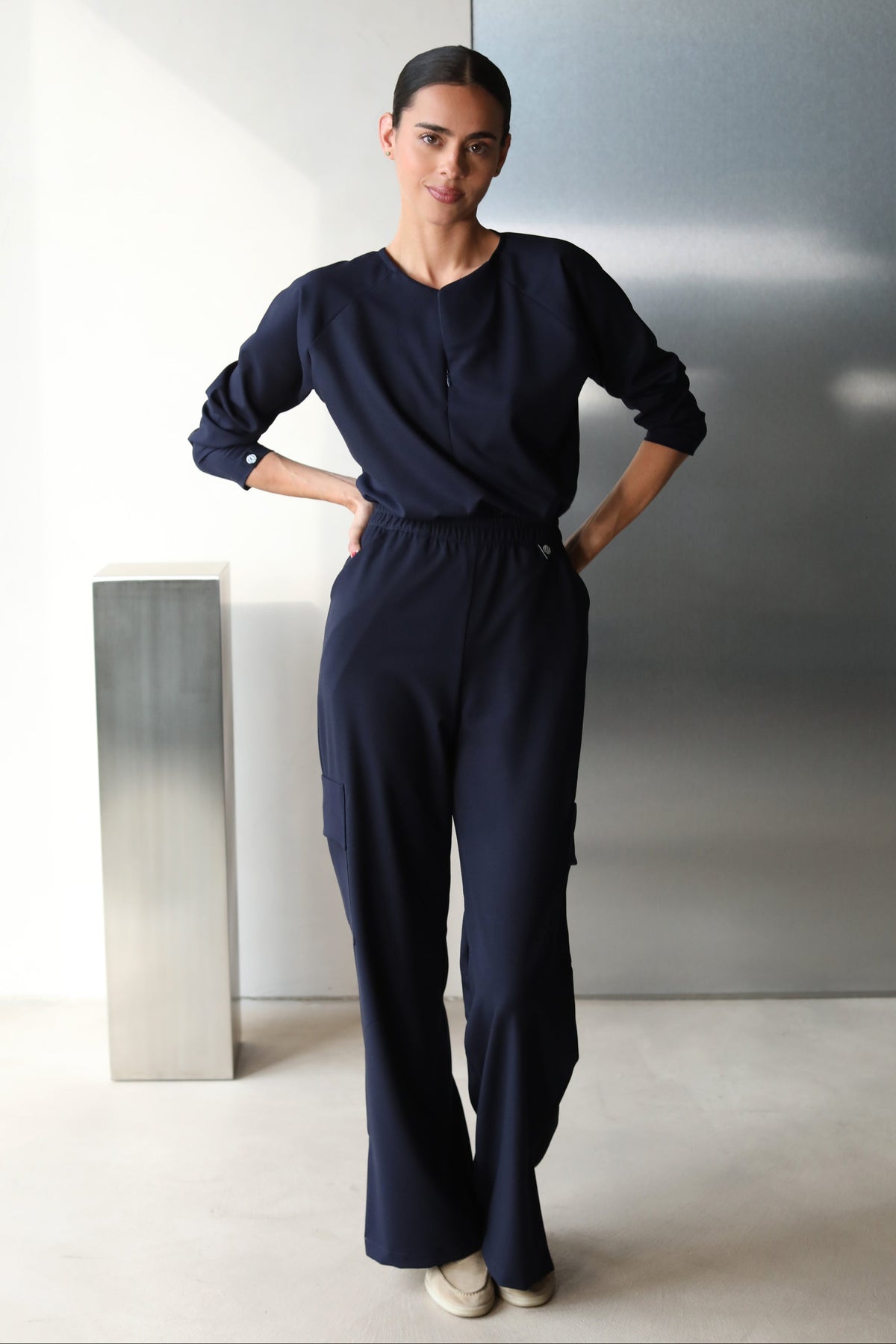 Side view of Fall Navy Scrub Top showing the long-sleeve fit