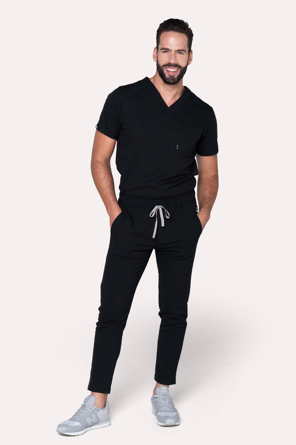 Man wearing Fresh Black Scrub Pants showing the tapered jogger silhouette