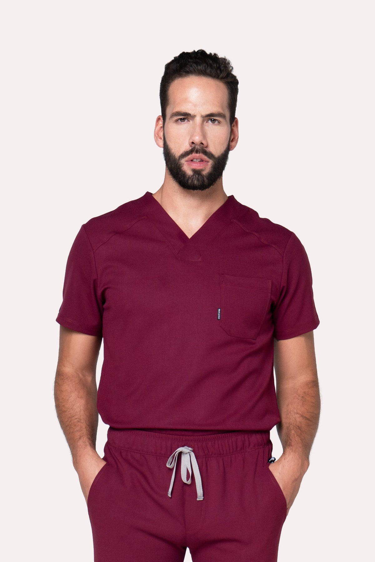 Model wearing Fresh Burgundy Scrub Top with matching Fresh Scrub Pants