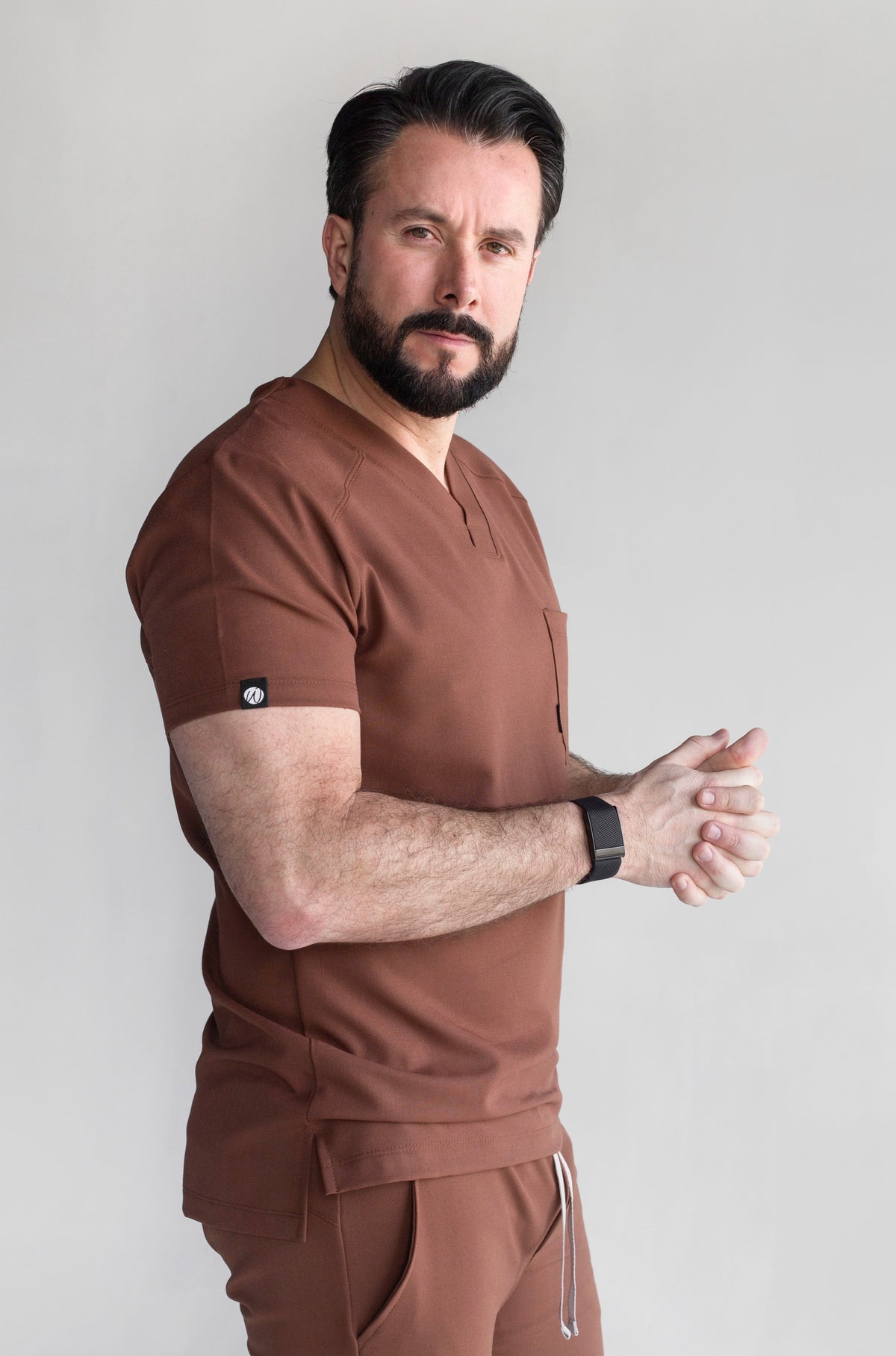 Side view of Fresh Cocoa Scrub Top showing the relaxed fit and V-neckline