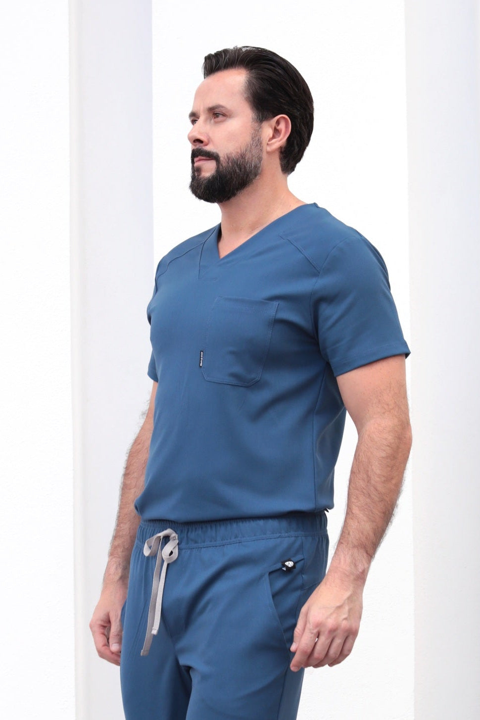 Side view of Fresh Indigo Scrub Top showing the relaxed fit and V-neckline