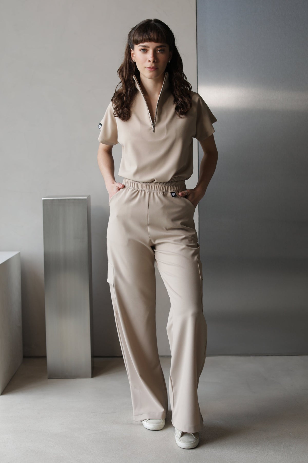 Model wearing Victory Natural Scrub Top with matching scrub pants