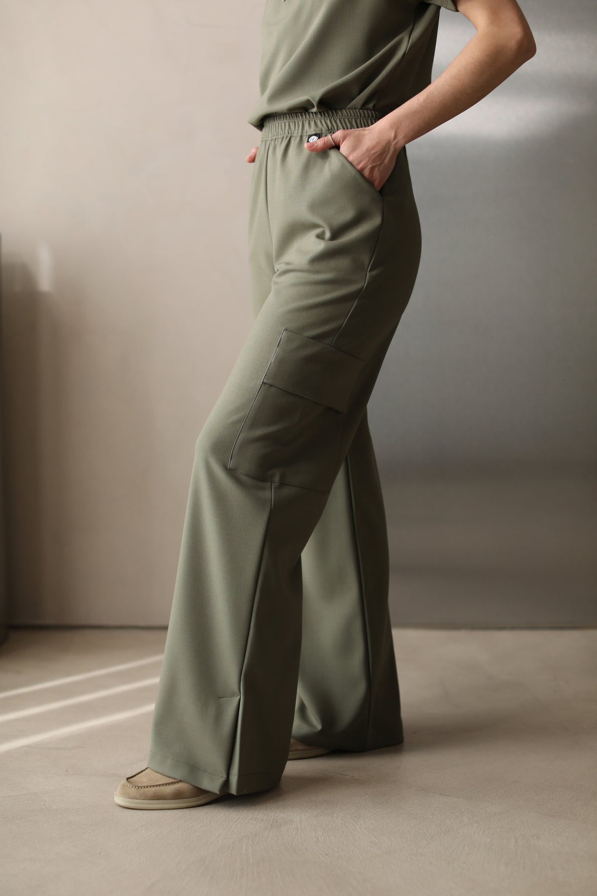Side view of Kate Olive Scrub Pants showing the wide-leg silhouette