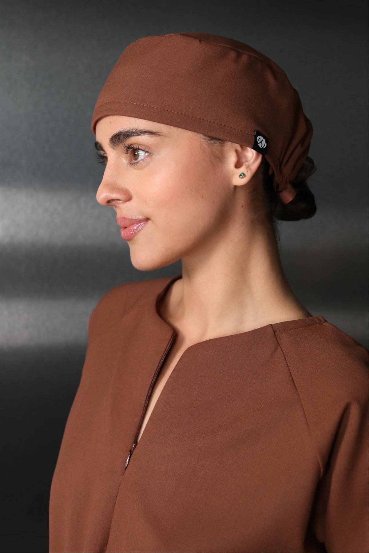 Healthcare professional wearing Black Women’s Surgical Cap with a white medical coat