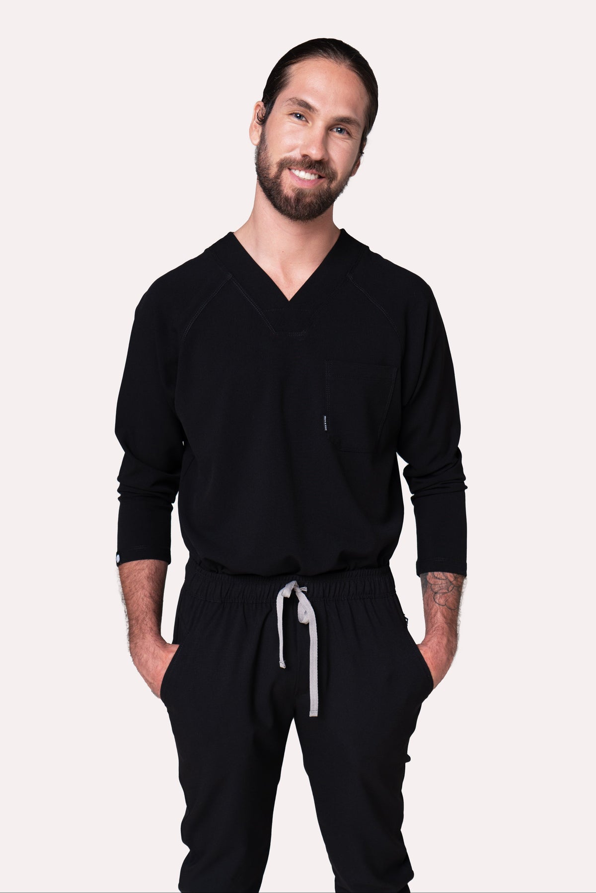 Model wearing Classic Black Scrub Top with black scrub pants