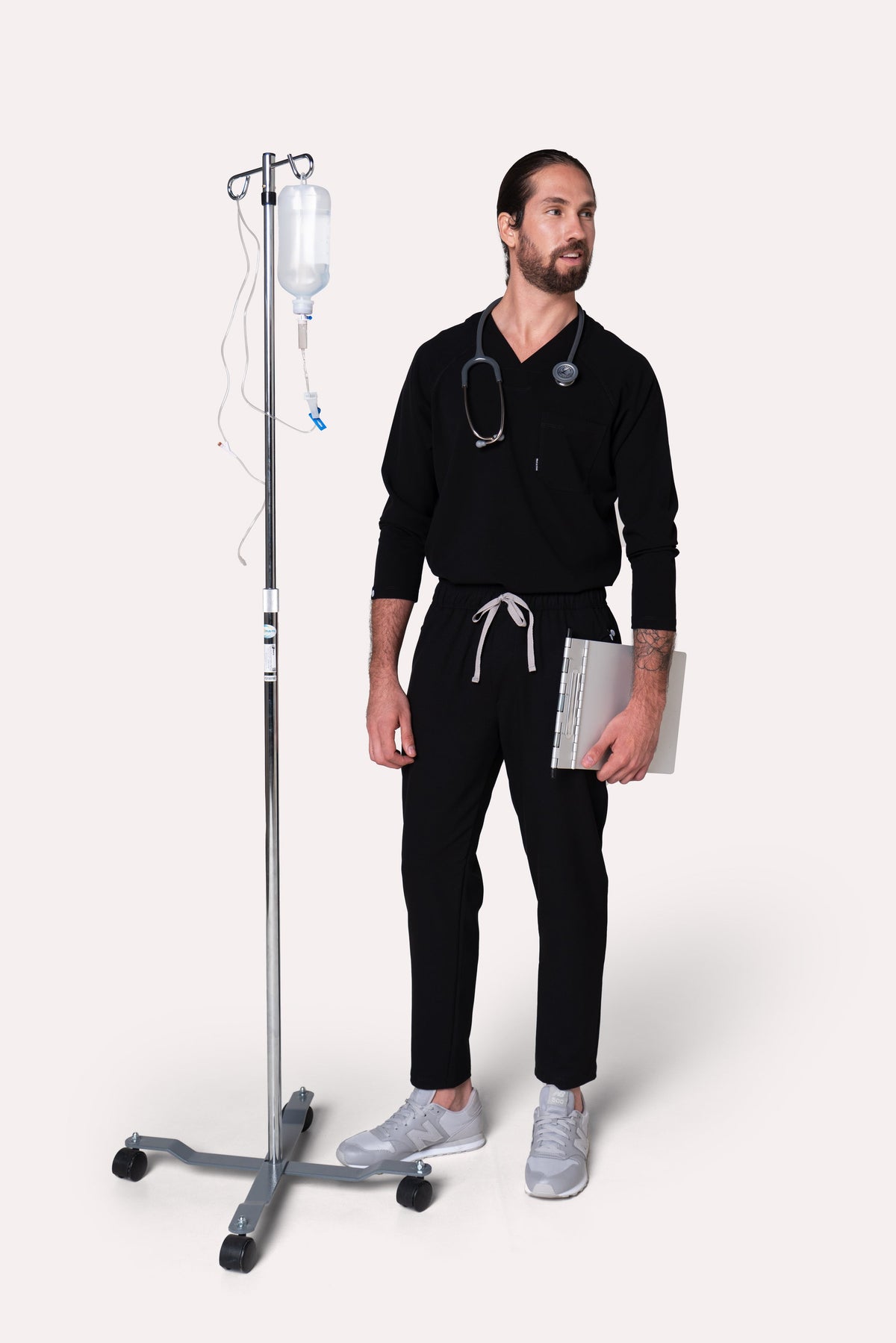 Healthcare professional wearing Classic Black Scrub Top in a clinical setting