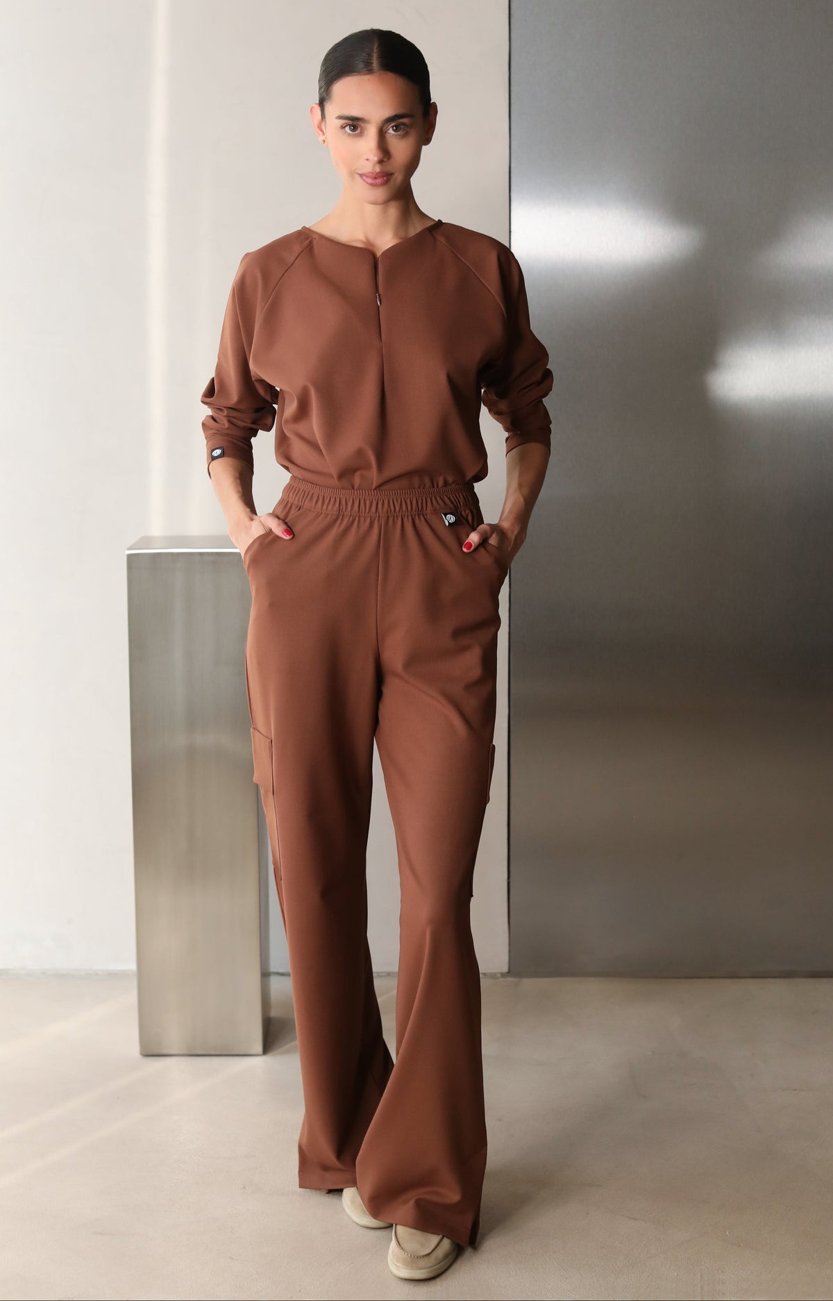 Model wearing Fall Cocoa Scrub Top with matching scrub pants