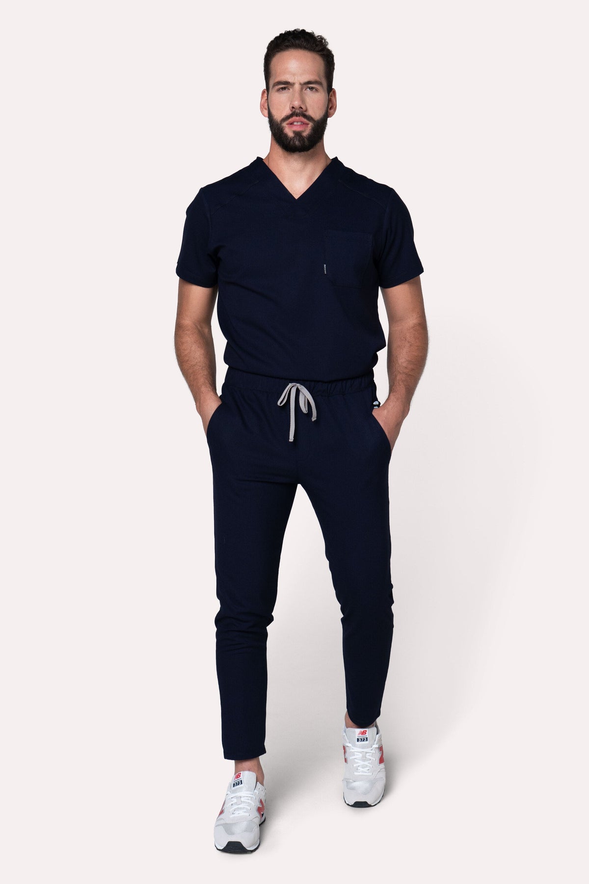 Man wearing Fresh Navy Scrub Pants showing the tapered jogger silhouette