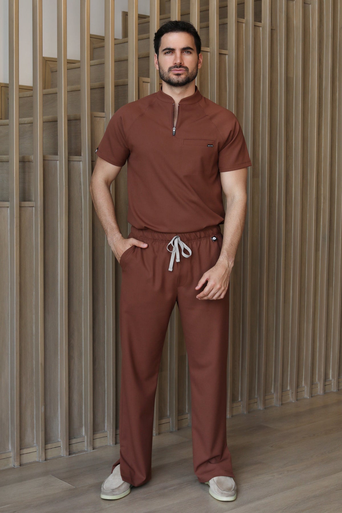 Full-body view of the Harry Cocoa Scrub Pants styled with the matching scrub top.