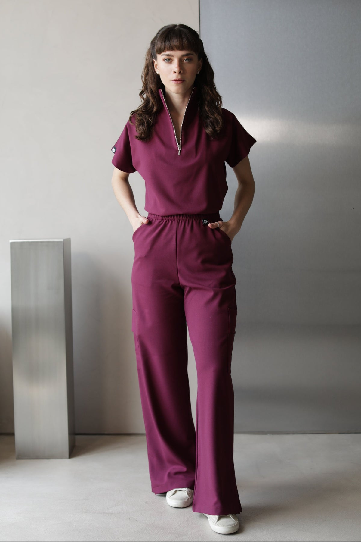 Model wearing Victory Burgundy Scrub Top with matching scrub pants