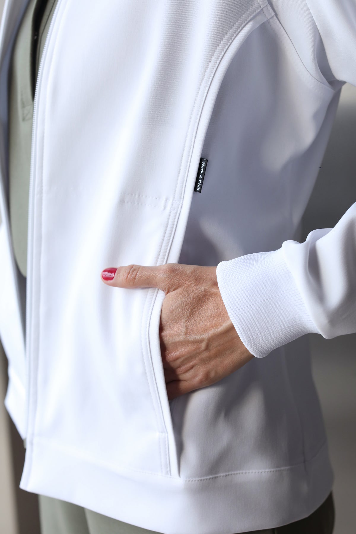 Close-up of Women’s White Medic Coat showing the functional front pocket